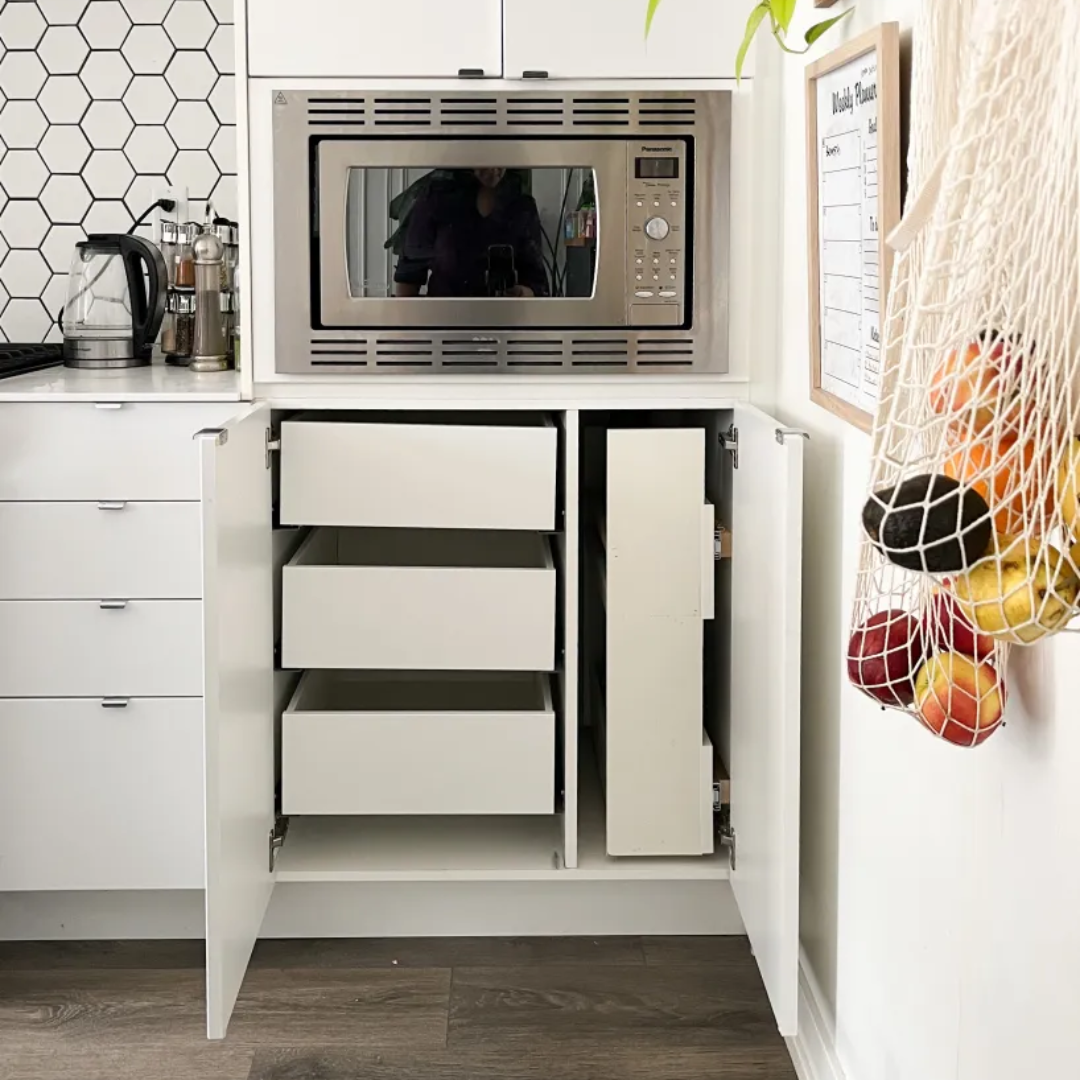 Installing pull-out shelves for better organization and storage in a small kitchen in Sarasota, FL.