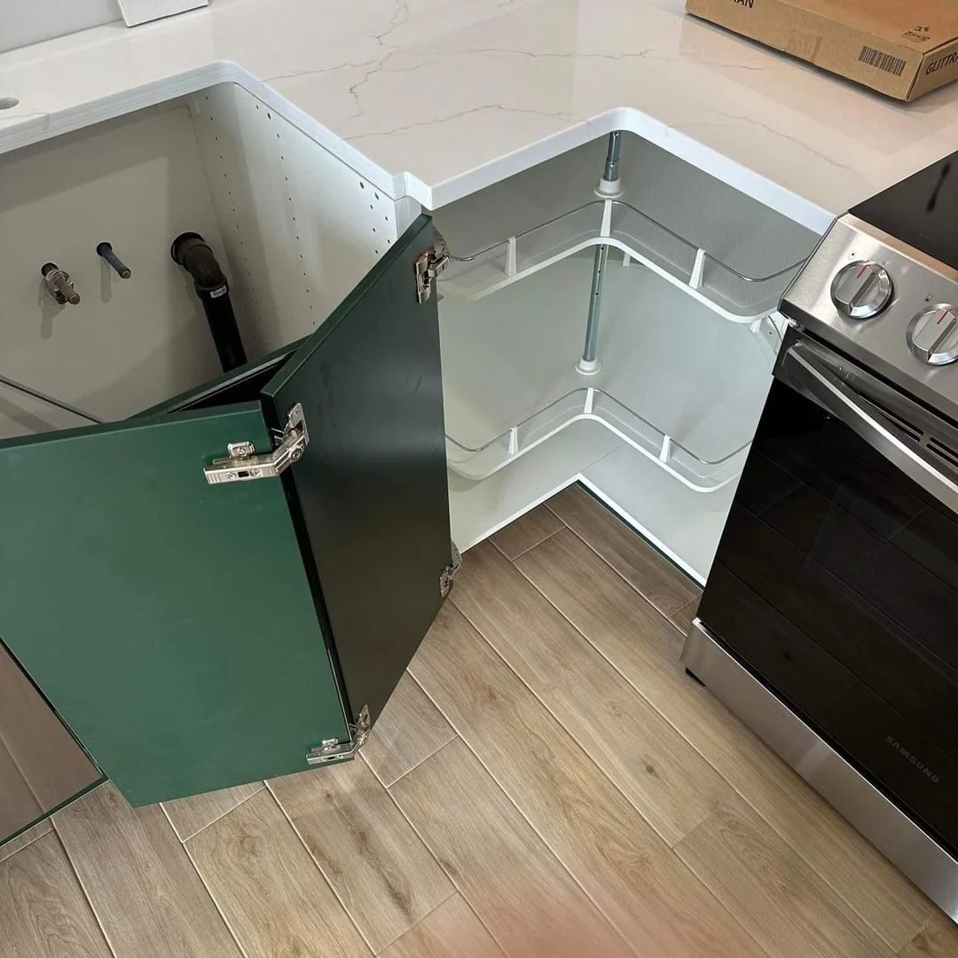 Installing a Lazy Susan for efficient corner storage in a small kitchen in Sarasota, FL.