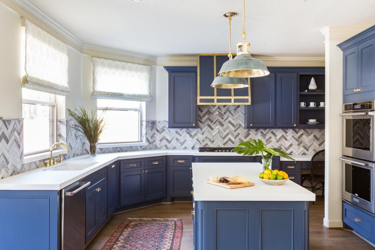 Kitchen with bold blue cabinets and gold hardware, creating a striking and modern statement.