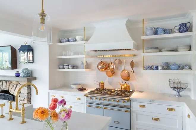 Vibrant kitchen with colorful appliances, including a bright blue refrigerator and red oven.