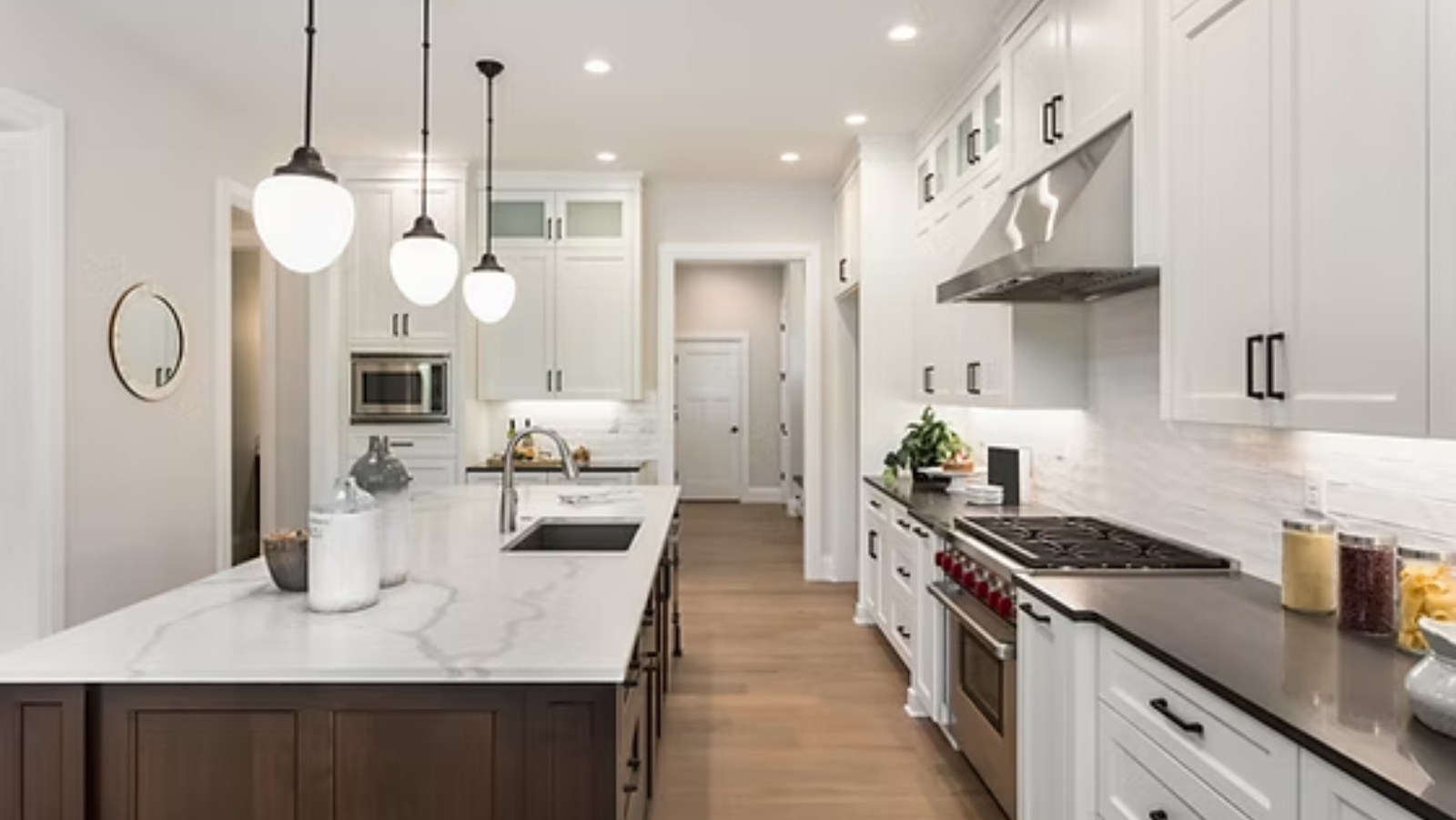 Elegant kitchen remodel with white shaker cabinets, quartz countertops, and a spacious island in Sarasota, FL.