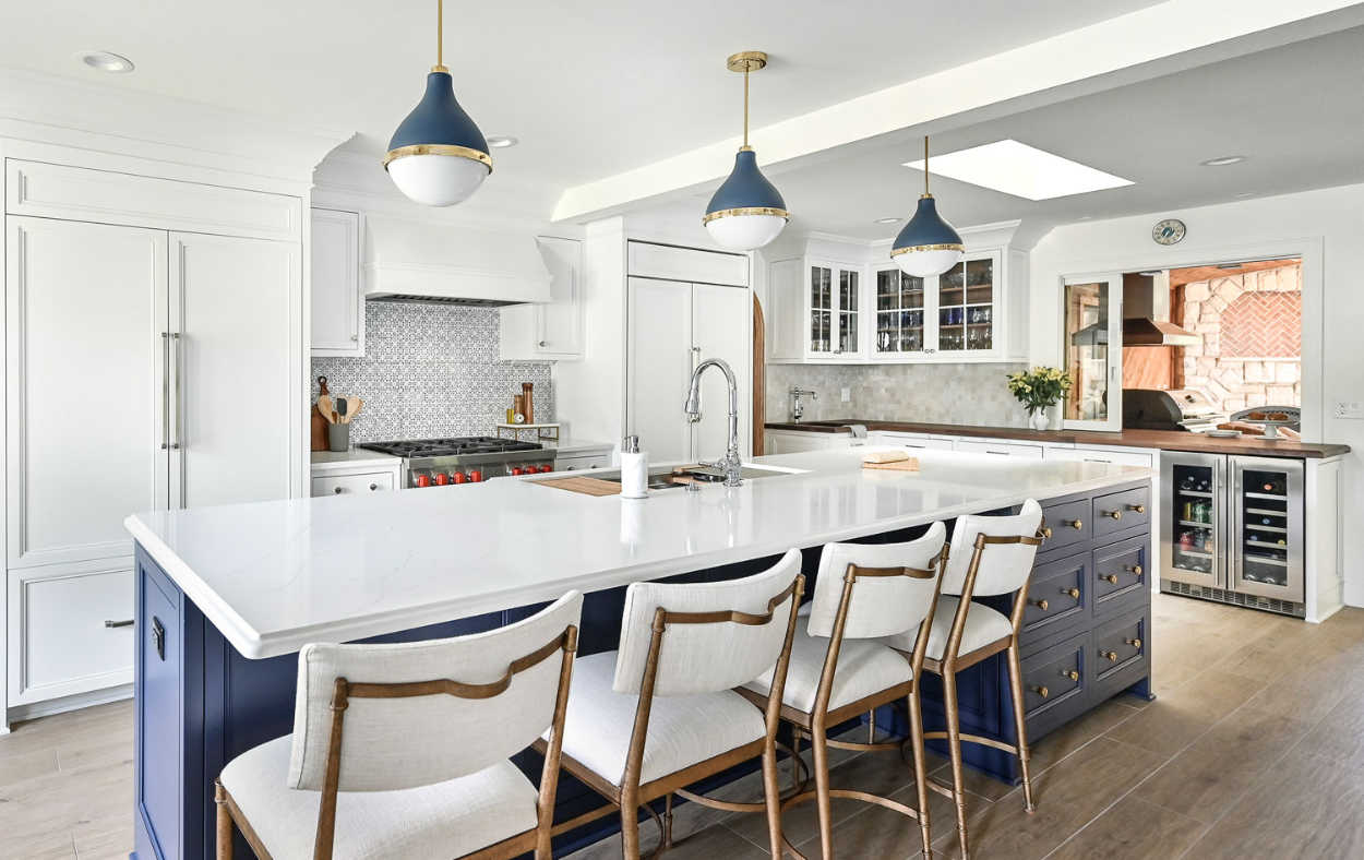 Bright and open blue and white kitchen remodel with stylish cabinetry and expansive countertops.