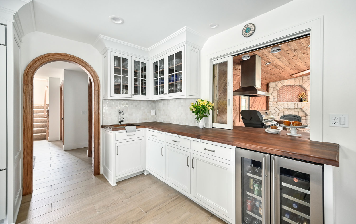 Spacious and airy blue and white kitchen remodel with a large central island and custom cabinetry.