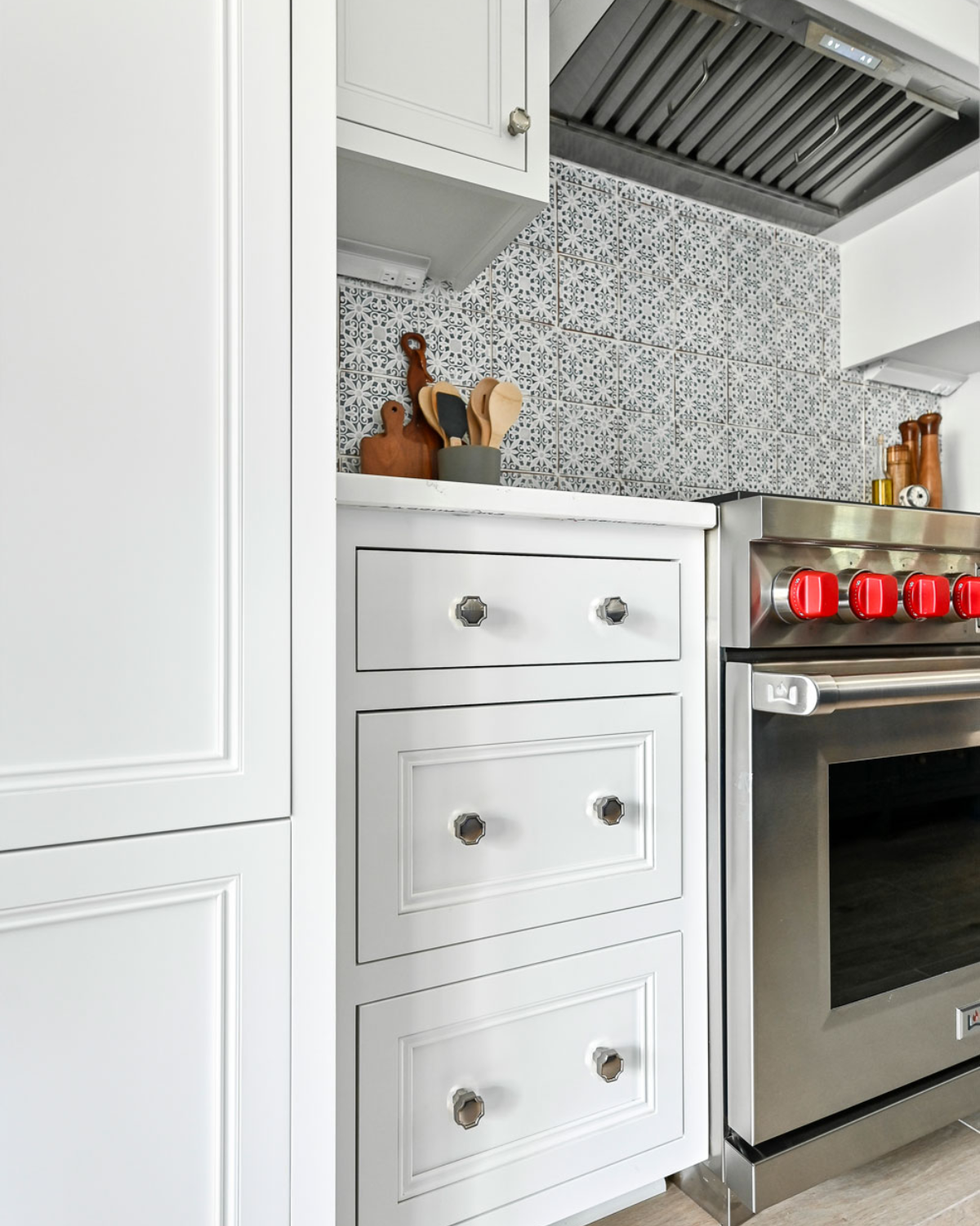 Spacious blue and white kitchen remodel featuring a large island, open shelving, and modern appliances.