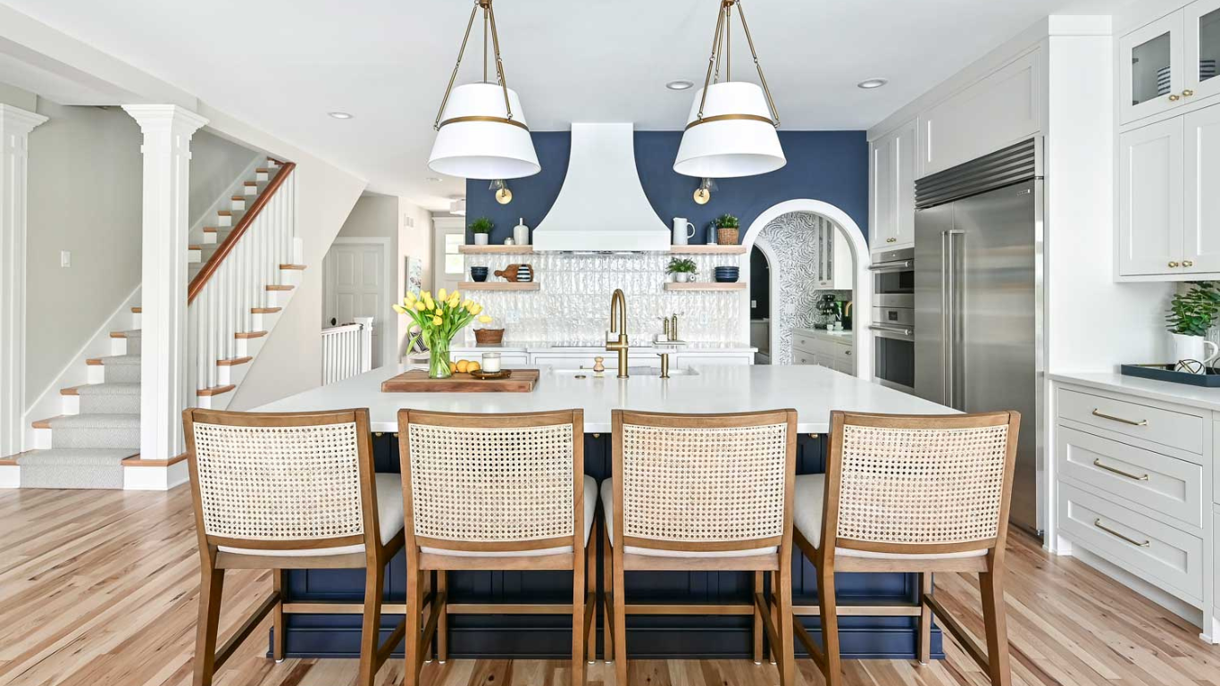 Luxury blue and white open-concept kitchen remodel in Sarasota, FL, featuring custom cabinetry, quartz countertops, and modern lighting.