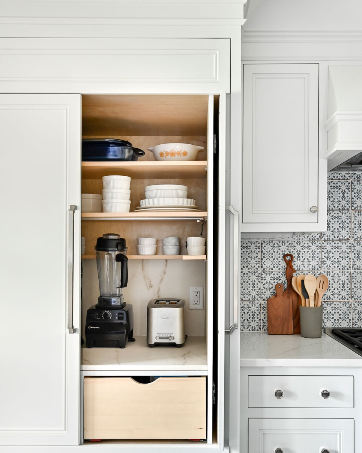 Modern blue and white kitchen cabinets with clean lines, integrated handles, and spacious storage