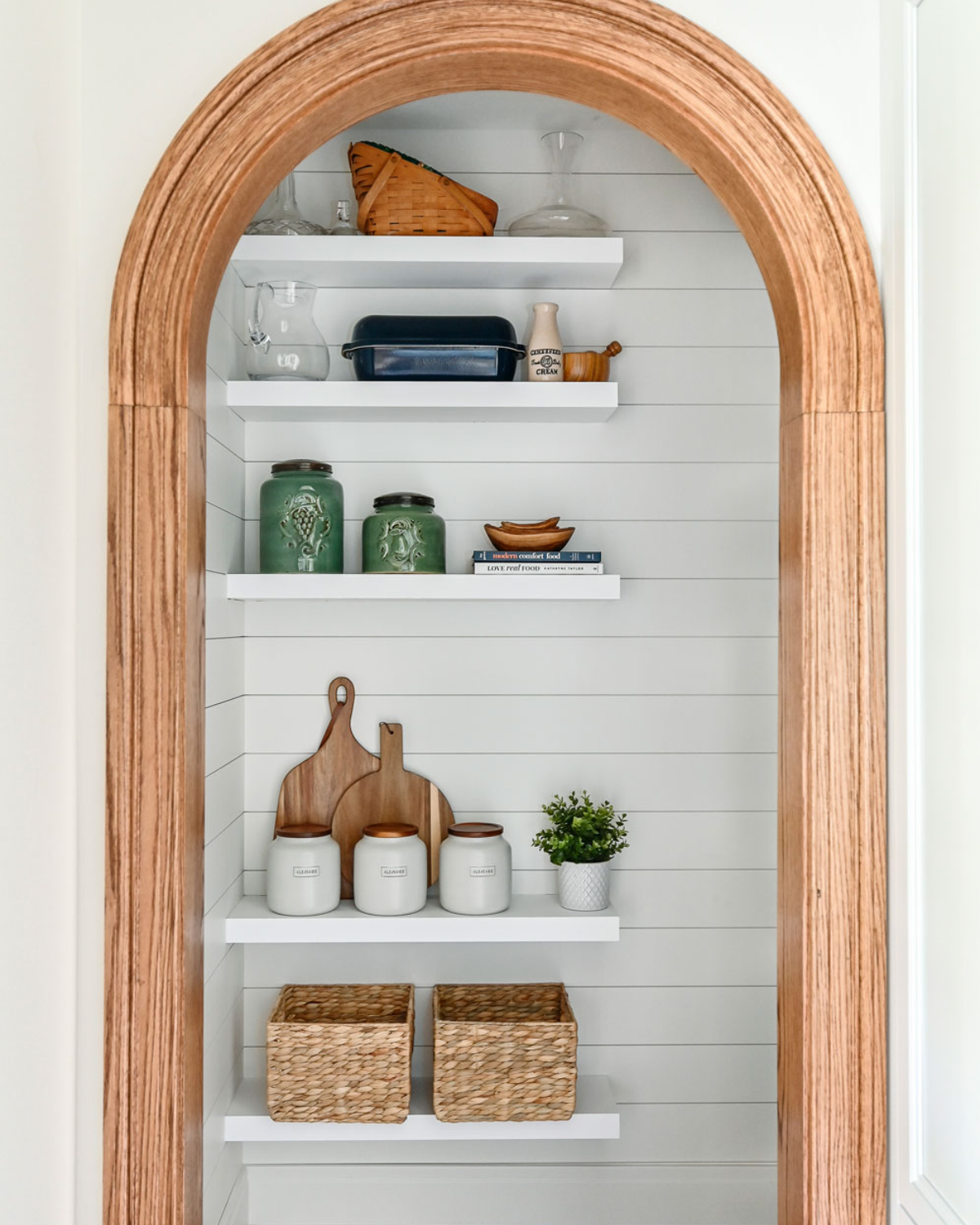 Spacious blue and white kitchen pantry with custom shelving and organized storage for kitchen essentials.