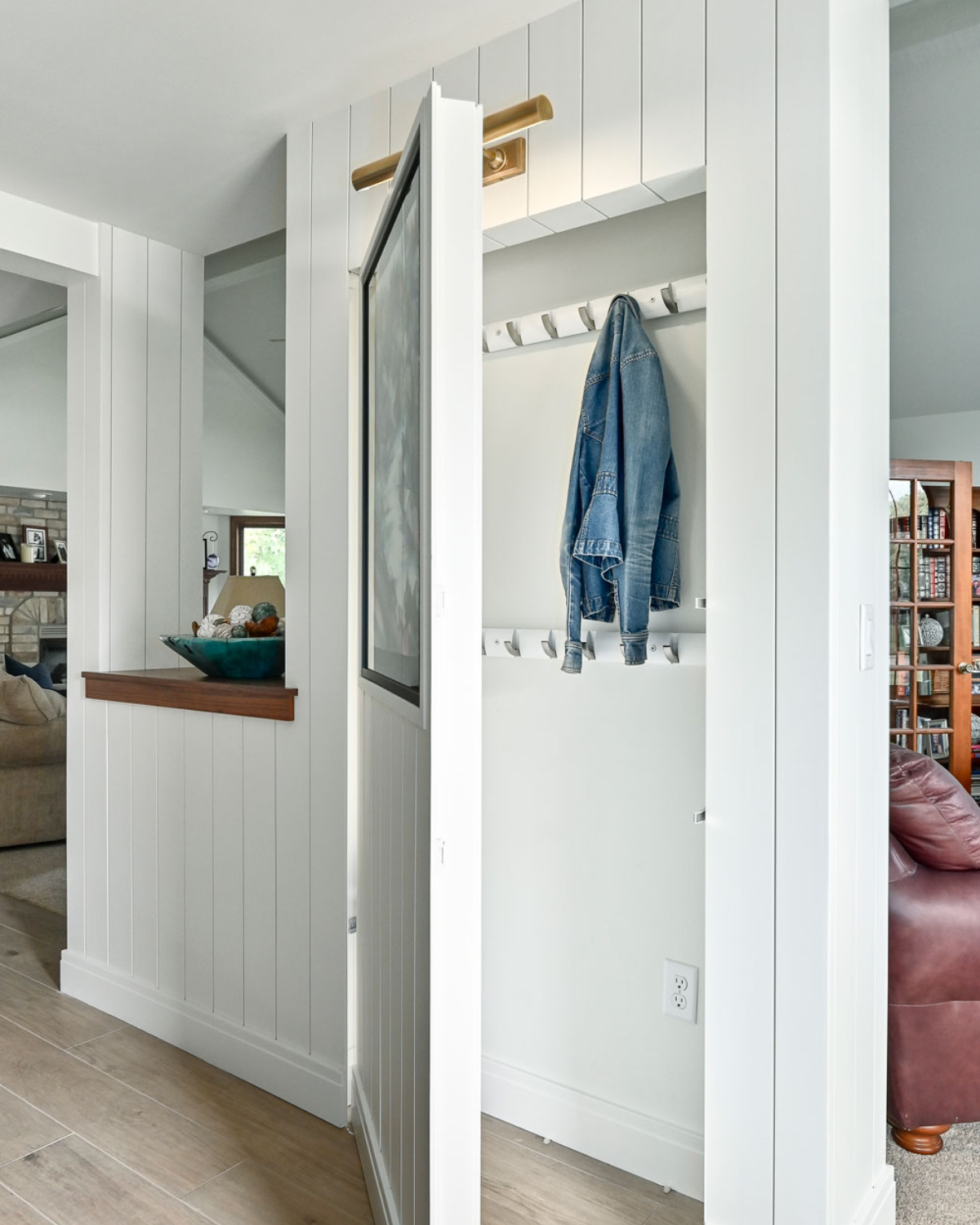 Custom-designed blue and white kitchen closet with organized storage for pantry items, cleaning supplies, and more.