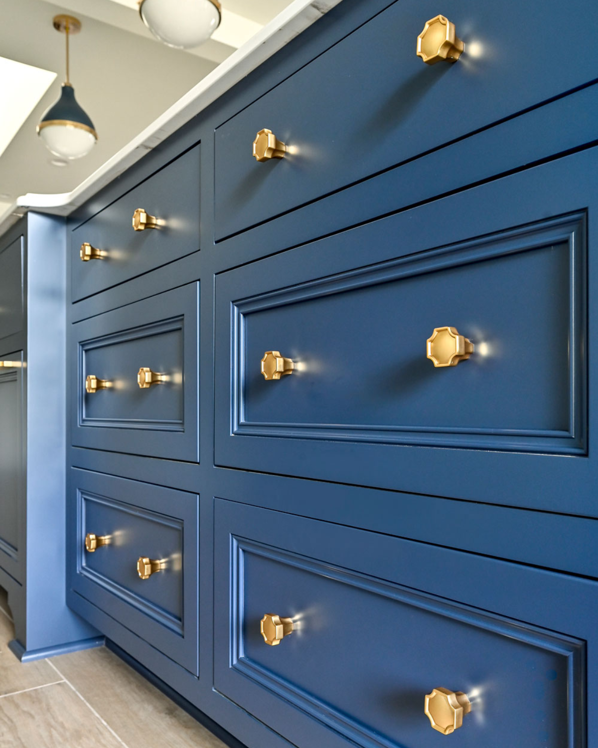 Custom blue and white kitchen cabinets featuring elegant design, ample storage, and sleek hardware.