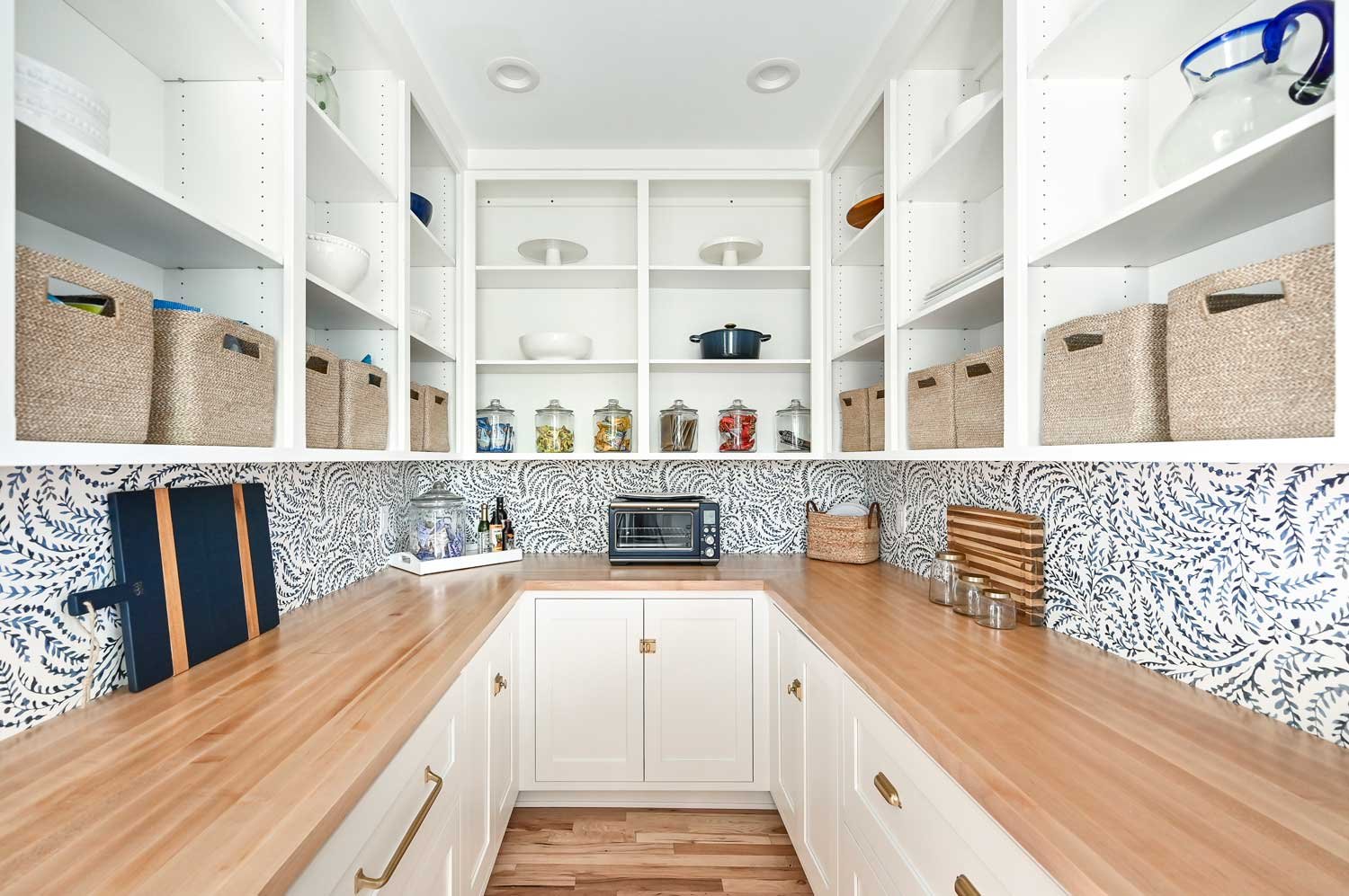 Spacious custom kitchen pantry with built-in shelving and organized storage in a Sarasota home.