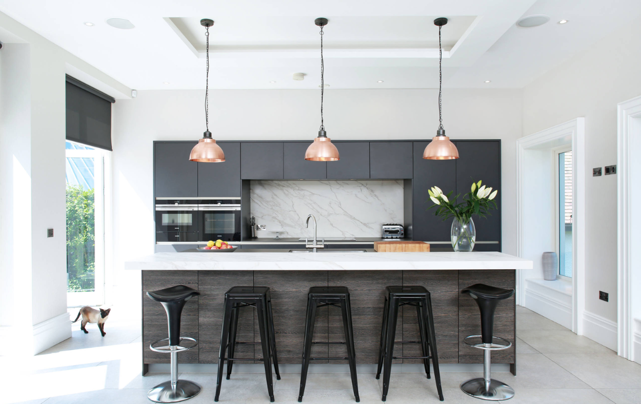 Warm under-cabinet and task lighting illuminating a modern Sarasota kitchen remodel for enhanced functionality and ambiance.